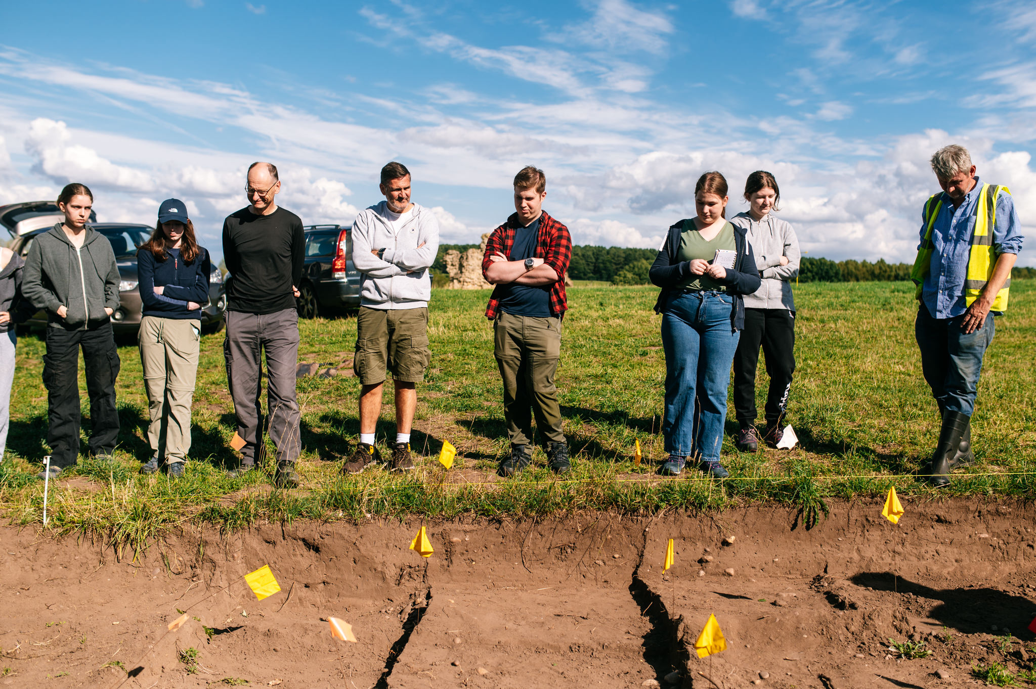 field school delegates stood on the edge of the trench they're about to start diggin in