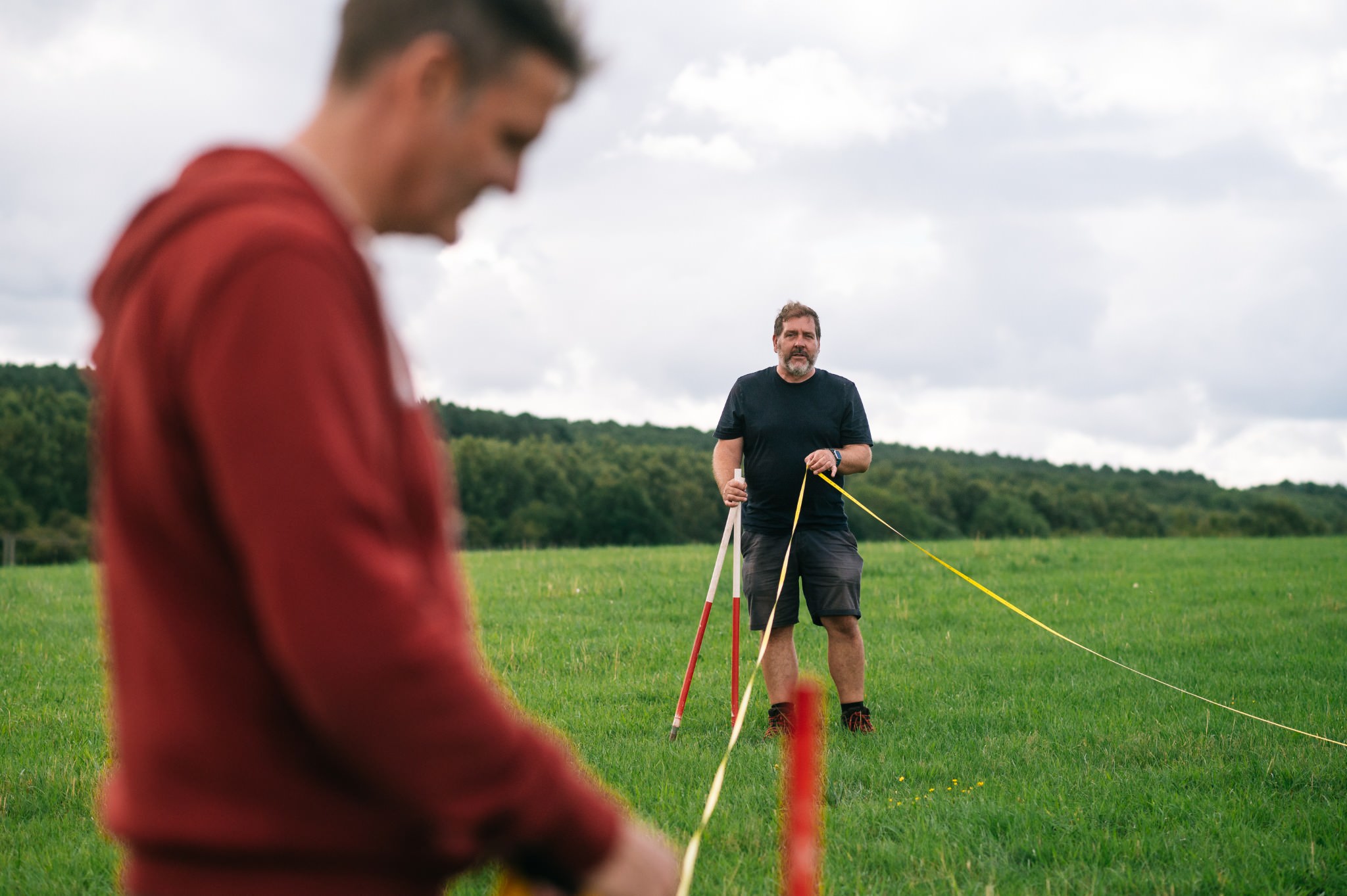 archaeologist holding measure tape