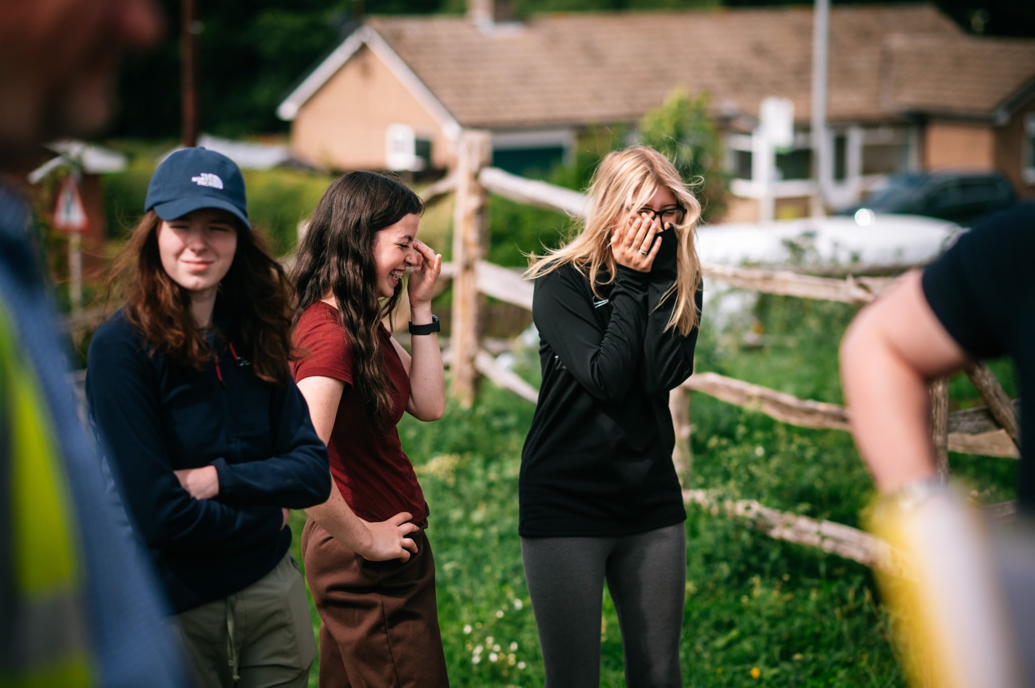 two students stood in a field laughing
