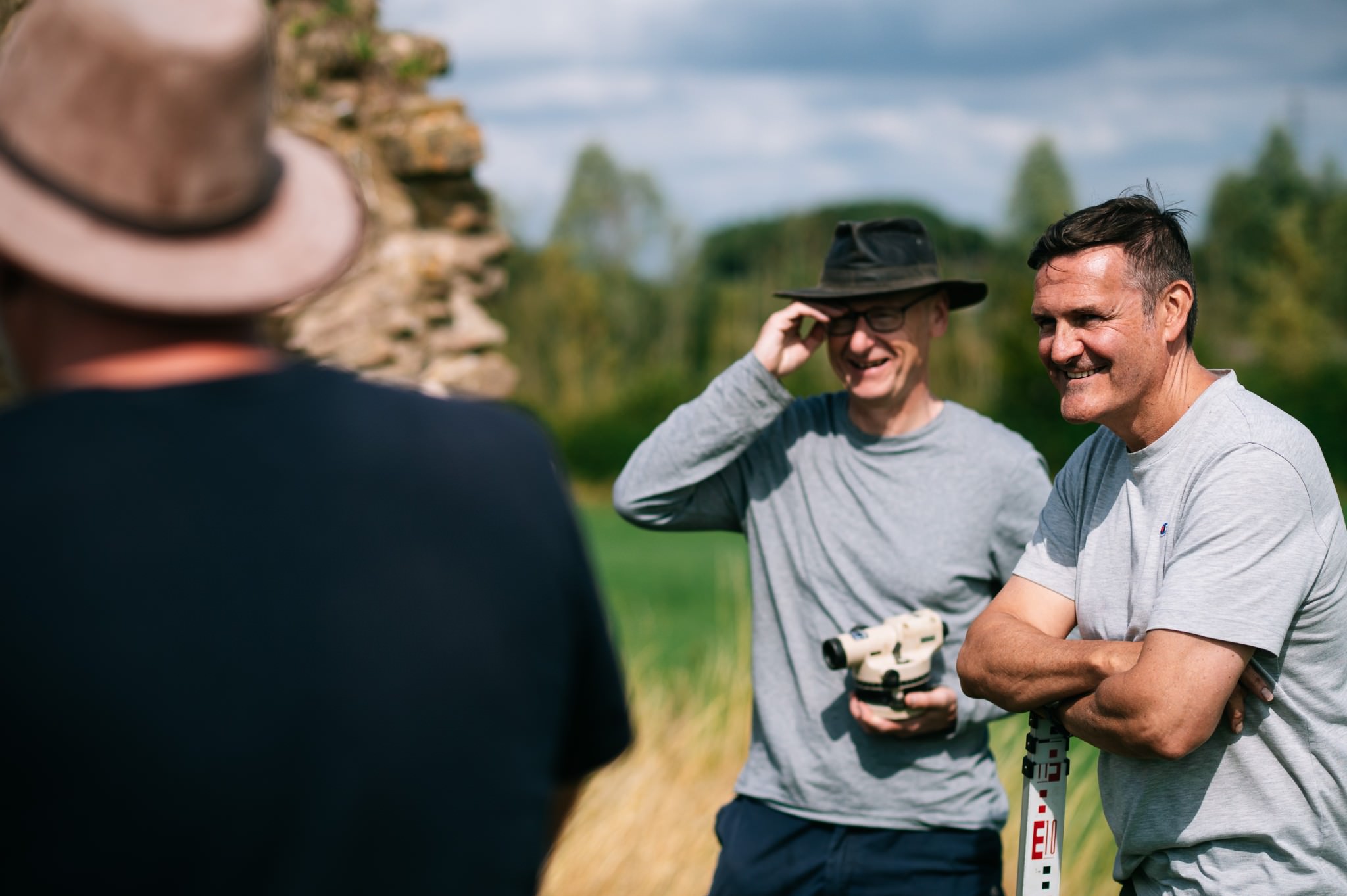 two men laughing whilst learning about topographic survey