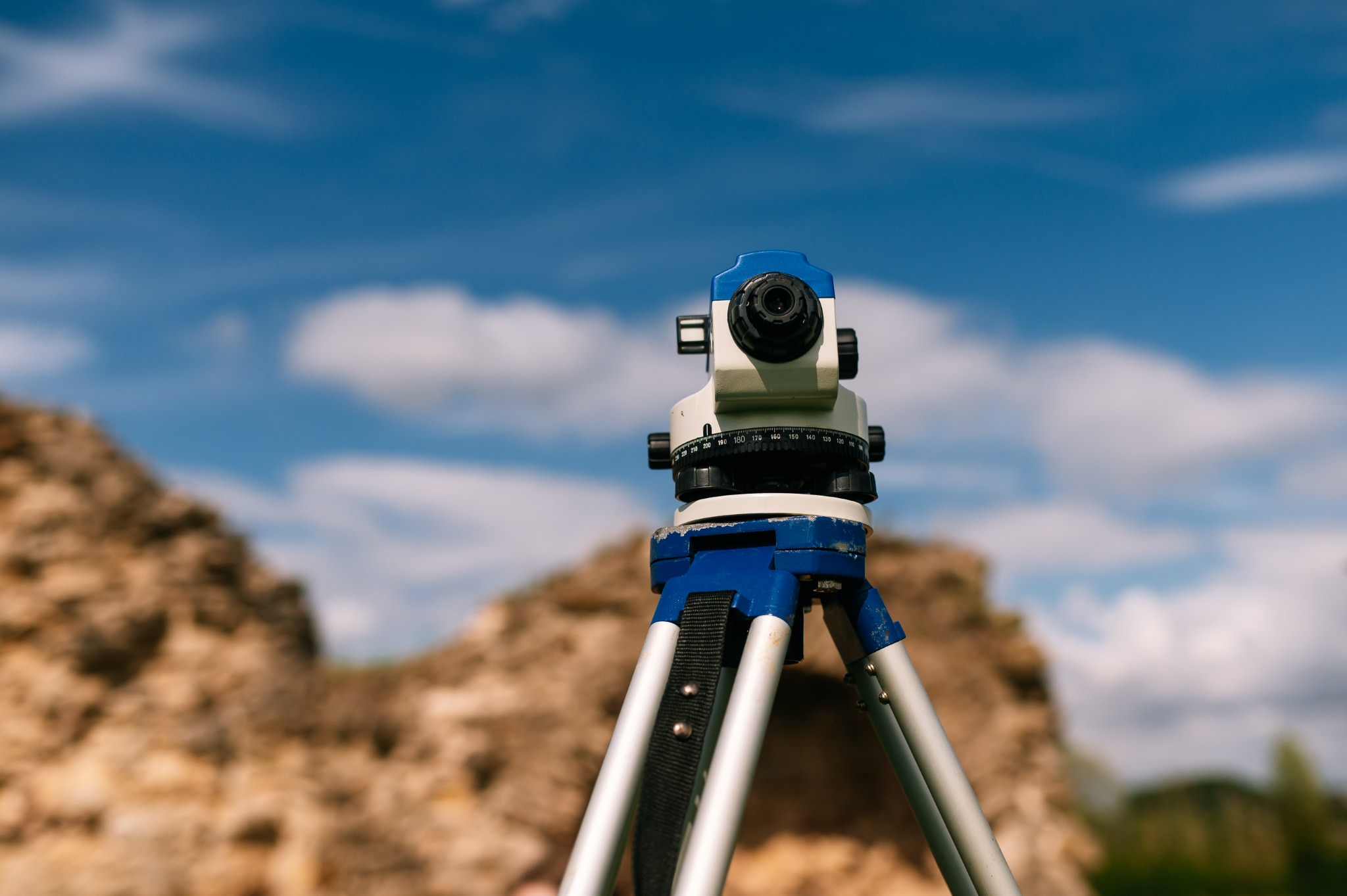 a dumpy level with ruins behind it and a blue sky