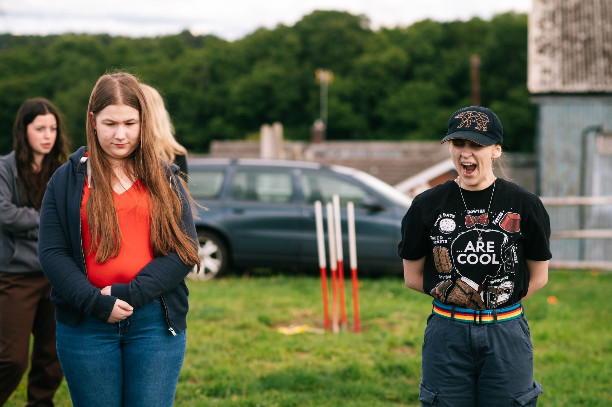 woman wearing a black cap and t-shirt yawning